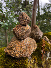 stone tower with sorrow stones and burden stones in the woods in portugal on the camino de Santiago, the road to santiago, christian pilgrimage