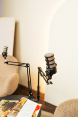 Podcast studio setting with microphone and chairs for engaging discussions and lectures