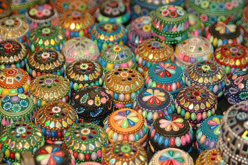 Many colourful beaded pots covered in multi-coloured pearls and glass beads