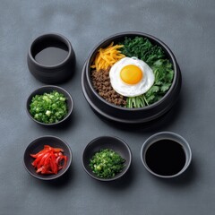 Korean food bibimbap side dishes concept. A vibrant bowl of bibimbap topped with a fried egg, surrounded by various side dishes.