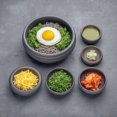 Korean food bibimbap side dishes concept. A bowl of mixed Korean ingredients with egg and side dishes arranged artfully.