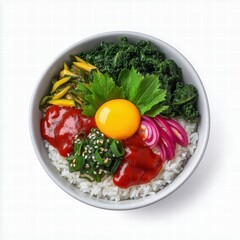 Korean food bibimbap side dishes concept. A colorful bowl of rice topped with vegetables, sauce, and a raw egg yolk.