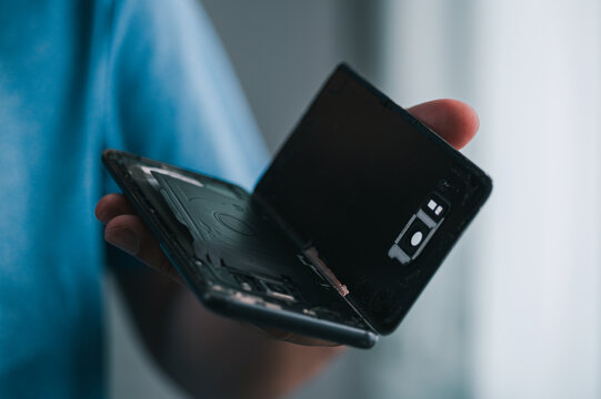 Broken smartphone handheld repair home technology indoor close-up handheld device