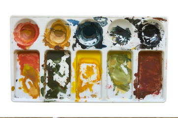 Palette with paints isolated on white background.