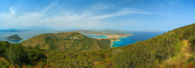 View of Golfo Aranci at Sardinia north, clear blue water beaches on both sides, from higher hill near