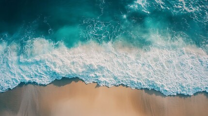 Waves crashing on a sandy beach, aerial view, aquamarine water with white foam
