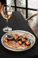 A beautifully crafted gourmet dish paired with exquisite white wine