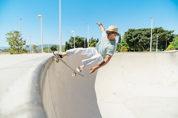 Skateboarder performing trick in skate park ramp © pacoocimage