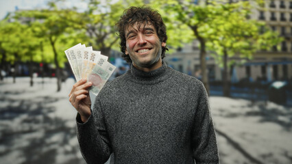 Man smiling holding czech koruna banknotes on a city street under sunny skies, showcasing a blend...