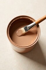 Paint can filled with rich brown color, featuring a clean brush resting on the rim, showcasing the texture and sheen of the paint for artistic and home improvement projects