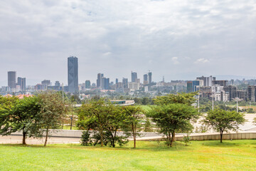 Modern skyscrapers of developing downtown district of Addis Ababa and green park in the foreground, Ethiopia