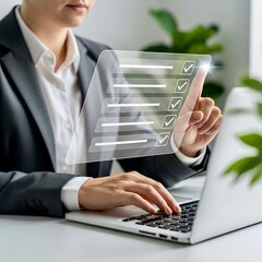 A professional completes a holographic checklist, interactively touching a completed item, while working on a laptop.
