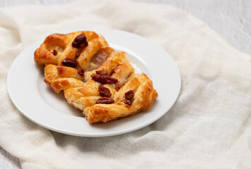 Danish pastry puff with dried fruits on plate