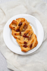 Danish pastry puff with dried fruits on plate