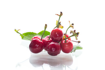 harvest of sweet red cherries on white background