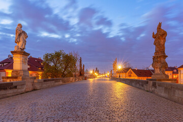 Charles Bridge with towers and sculptures at dawn in Prague, Czech Republic