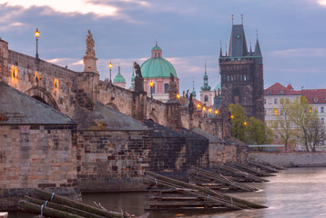 Charles Bridge with towers and sculptures at dawn in Prague, Czech Republic