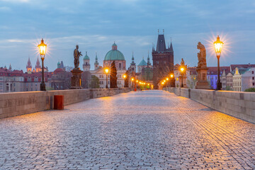Charles Bridge with towers and sculptures at dawn in Prague, Czech Republic