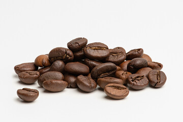 A pile of coffee beans on a white background