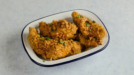 Crispy, golden fried chicken pieces are neatly arranged, waiting to