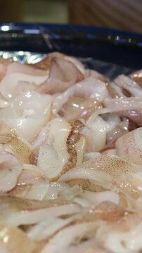 pieces of raw squid, close-up, on a plate. Sliced raw squid