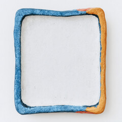 Handmade ceramic tile frame with decorative painted border in blue and white watercolor style. Artisan pottery square with ornate edge design creates rustic Mediterranean inspired accent piece
