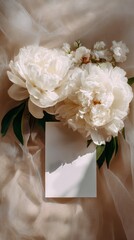 Fototapeta premium Elegant White Peonies With Blank Card on Soft Fabric Background for Special Occasions
