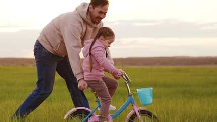 Parent teaching child to cycle, First bike riding memory, Cycling in open field joy, The excitement of learning biking, Daughter happy with father s help, Perfect countryside setting for family time - Powered by Adobe