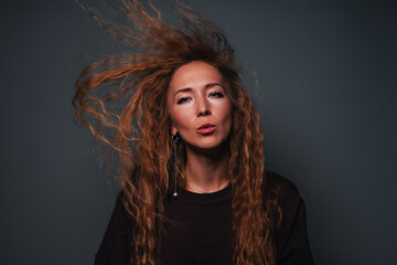 Young beautiful woman with flowing hair studio fashion portrait