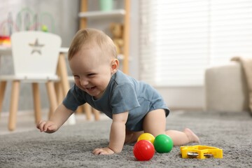 Cute little baby crawling on floor at home