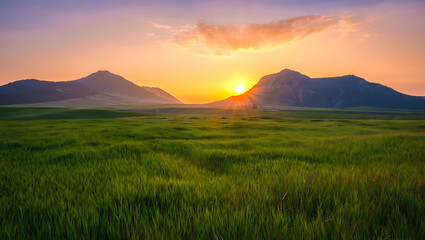 Obraz premium A beautiful mountain landscape at dawn with a vibrant orange sky, misty hills, and light clouds