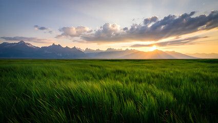 Obraz premium Dramatic mountain landscape at sunrise or sunset, featuring a panoramic view of misty hills and cloud-kissed peaks under a vibrant sky