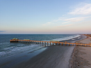 Aerial shot of a fishing pier on the beach in South Carolina on a sunny day