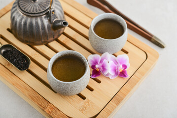 Traditional asian tea ceremony arrangement: ceramic teapot, cups and bamboo chaban