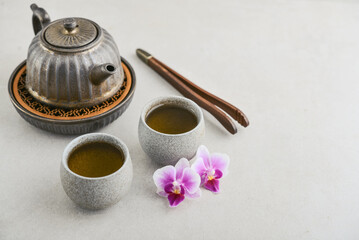 Traditional asian tea ceremony arrangement: ceramic teapot, cups and teapot tray