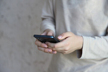 
Teenager with cell phone in hands
