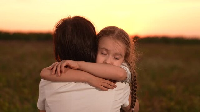 Mother child comforting sad daughter at sunset, emotional family moment outdoors, girl child kid hugging mom after a long day, loving embrace nature, parent child support during hard times, expressing