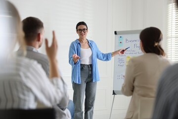 Fototapeta premium Woman giving public speech in front of audience indoors