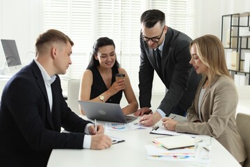 Marketing. Team of businesspeople working together at desk in office