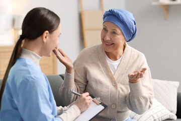 Fototapeta premium Woman with cancer and nurse at home