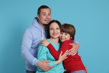 Portrait of happy family on light blue background