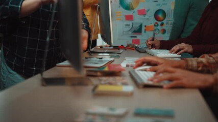 A diverse group of professionals collaborates in a modern office, engaging in brainstorming sessions, working on digital devices, and fostering a creative environment. SACTR