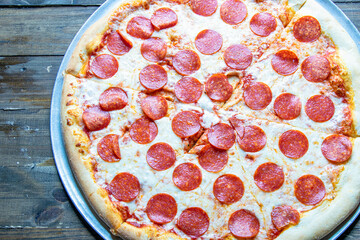 Tasty Italian pizza with spinach, pepperoni, cheese, and mushrooms