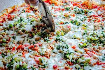 Tasty Italian pizza with spinach, pepperoni, cheese, and mushrooms