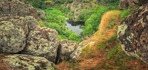 panoramic view to canyon with granite stones and water source