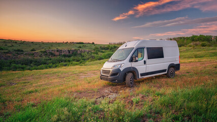 landscape view to white camper van in sunset time in canyon with copy space