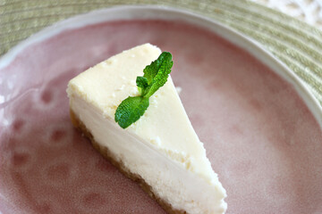 A piece of cheesecake on a plate on a table