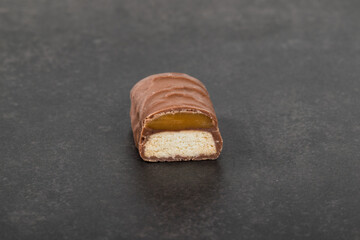 Mini Chocolate bar with caramel and cookie. Dark backgraund. Close up
