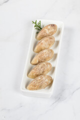 Homemade Jellied meat in the shape of a quenelle. On a plate.