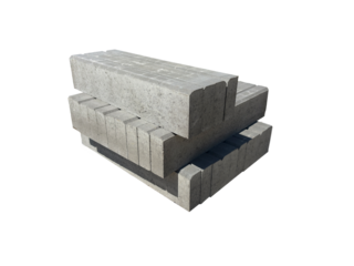 A pile of grey concrete blocks for building curbs, A stack of curbs